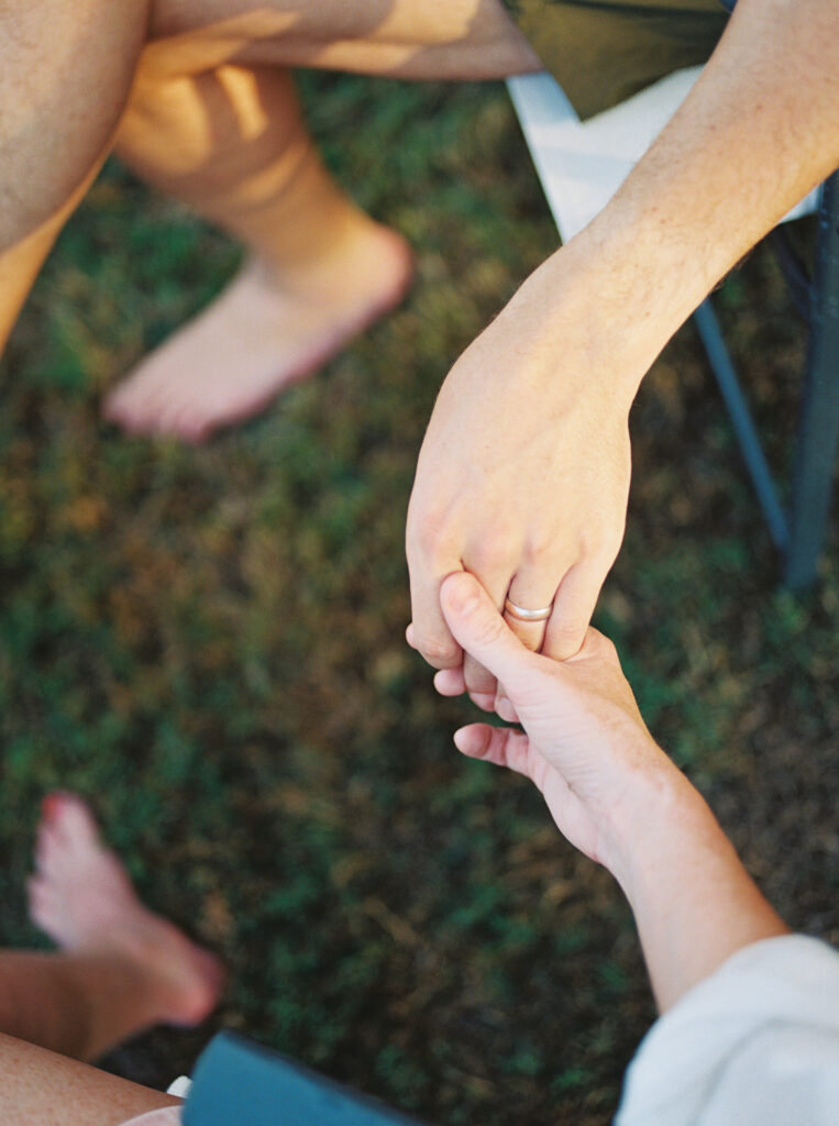 Mother and father's hands interlocked